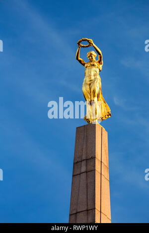 Close-up of gold statue on top of the Monument of Remembrance against blue sky; Luxembourg City, Luxembourg Stock Photo