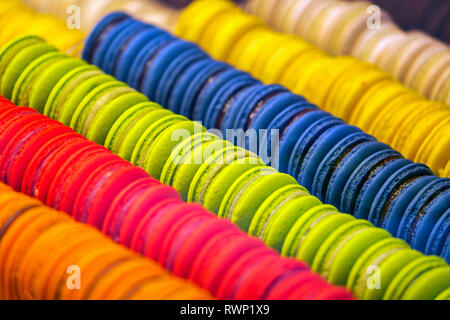 Close-up of colourful macaroons all in a row in store showcase; Luxembourg City, Luxembourg Stock Photo