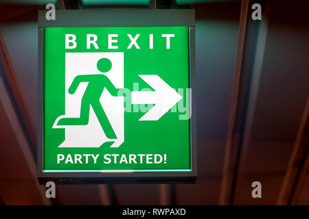 The emergency exit sign shows the direction of escape in case leave European Union. The board indicate way for Brexit. Stock Photo