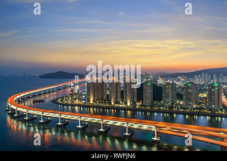 Busan city skyline view at Haeundae district, Gwangalli Beach with yacht pier at Busan, South Korea. Stock Photo