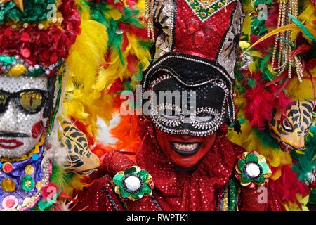 Dancers wearing colorful costumes at the Battle of Flowers Stock Photo