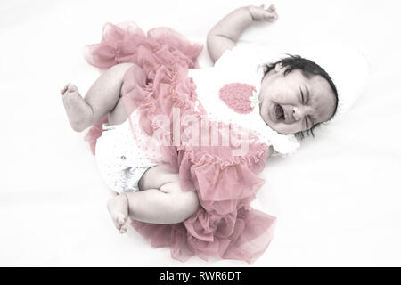 Infant in purple cap Stock Photo