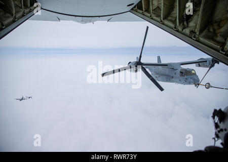 Naval aviators with Marine Medium Tiltrotor Squadron 262 (Reinforced) position an MV-22B Osprey tiltrotor aircraft during aerial refueling with a KC-130J Super Hercules from Marine Aerial Refueler Transport Squadron (VMGR) 152 off the coast of Japan, Feb. 28, 2019. U.S. Marines with VMGR-152 provide a wide range of capabilities throughout the INDOPACOM area to include aerial refueling, personnel and cargo transportation, and aerial delivery. (U.S. Marine Corps photo by Lance Cpl. Tyler Harmon)