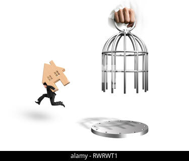 Hand opening the cage and man carrying red wooden house running, isolated on white background. Stock Photo