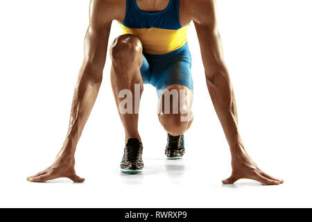 Young caucasian man preparing to run isolated on white studio background. One male runner or jogger. Silhouette of jogging athlete with shadows. Stock Photo