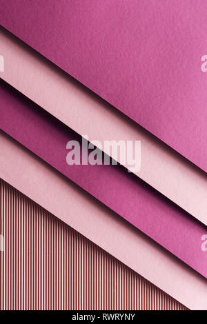 top view of pink and burgundy sheets of paper on pink background with copy space Stock Photo