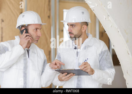 busy construction engineer talking on phone Stock Photo