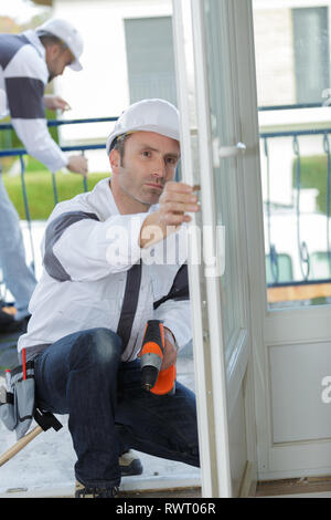 carpenter works with drill Stock Photo