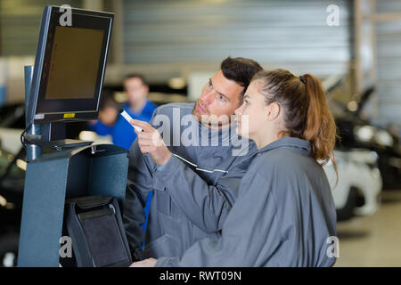 female mechanic running a diagnostics program Stock Photo