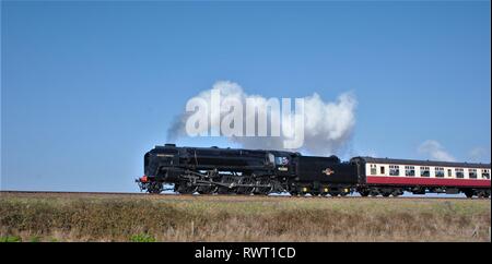 Black Prince, large black steam engine steaming through the countryside on a bright sunny day Stock Photo