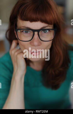 red haired woman with eye glasses  and a preaty face Stock Photo