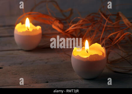 Happy easter composition with eggs and candles on Rustic background. Selective focus. Stock Photo