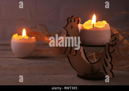 Happy easter composition with eggs and candles on Rustic background. Selective focus. Stock Photo