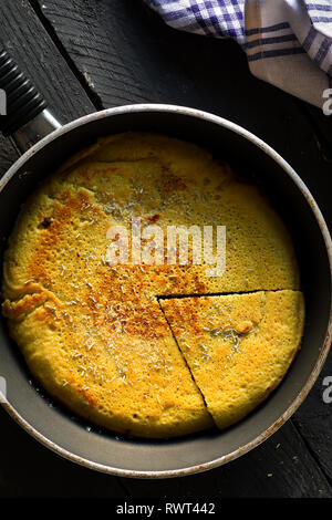 Sliced Vegan Chickpea Omelette On a Frying Pan Stock Photo