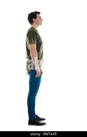 Full length side view of casual young man standing relaxed looking ahead  isolated over white background Stock Photo - Alamy