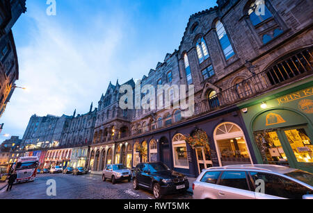 Dusk view of historic buildings and shops on Victoria Street in Edinburgh Old town, Scotland, UK Stock Photo