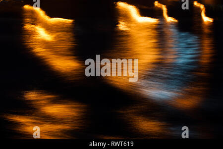 Abstract shapes on water surface at night Stock Photo