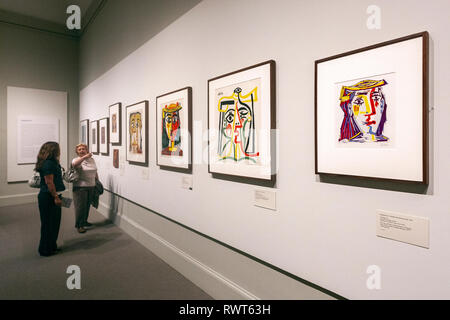 Visitors in a Pablo Picasso hall with the Jacqueline in a Multicolored Straw Hat, The Metropolitan Museum of Art, Manhattan, New York USA Stock Photo