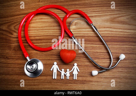 Medical Insurance Concept. Family cutout and Stethoscope on wooden background Stock Photo