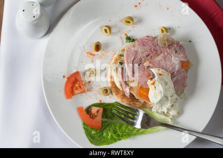 Entree dish of Ham hock terrine on buttered toast with a natural yogurt dip Stock Photo