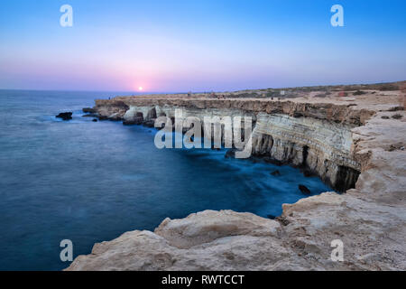 View of cliff with sea caves at sunset on Cape Greco near Ayia Napa, Cyprus (HDR image) Stock Photo