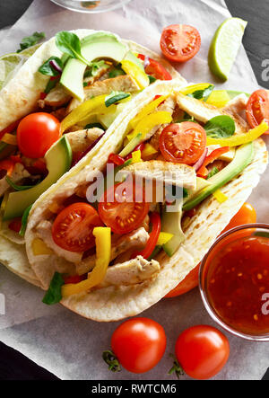 Tasty healthy tacos with chicken meat and fresh vegetables. Stock Photo