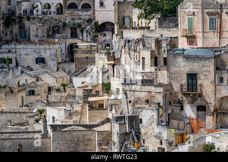 MATERA, ITALY - AUGUST 27, 2018: Warm scenery summer day high angle close-up street view of amazing ancient town of the famous Sassi with wonderful bu Stock Photo