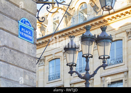 PARIS, FRANCE - JULY 21, 2017: Famous Place Vendome corner with street sign and lamp in Paris, France. Stock Photo