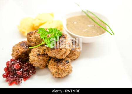 Meatballs stewed with vegetables on white background Stock Photo