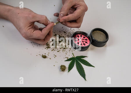 Cannabis pipe with hemp leaves drawings on it and a grinder with cannabis  in it Stock Photo - Alamy