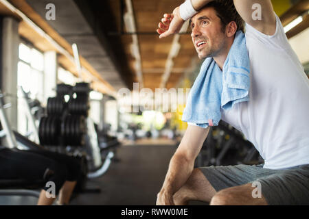 Handsome sporty man resting, having break doing exercise Stock Photo