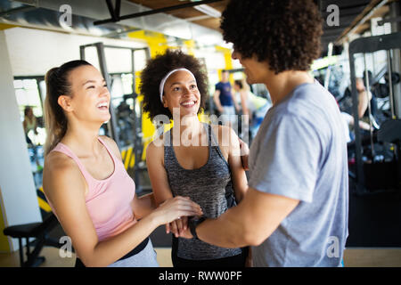 Happy gorup of healthy people training in gym Stock Photo