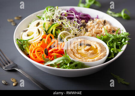 veggie couscous lunch bowl with spiralazed carrots and zucchini, hummus and red cabbage Stock Photo