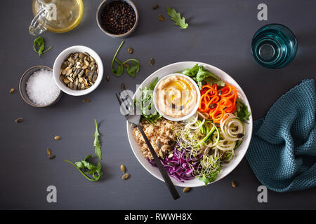 veggie couscous lunch bowl with spiralazed carrots and zucchini, hummus and red cabbage Stock Photo