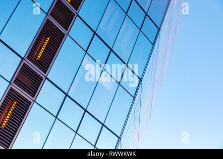 Modern business architecture abstract fragment, office building corner made of glass and steel under blue sky Stock Photo