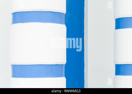 Abstract architectural fragment, white columns with blue stripes Stock Photo