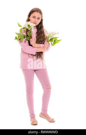 Girl 10-11 years old in a pink suit holding white lilac in her hands. Isolation on a white background Stock Photo