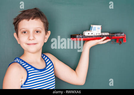 Schoolboy with his own hand built model boats Stock Photo