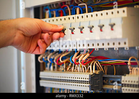 Male electrician working with equipment. Close up Stock Photo