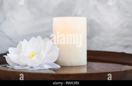 Spa still life with candle and water lily, spa still life composition natural wellness still life with candle and lotus in water background Stock Photo
