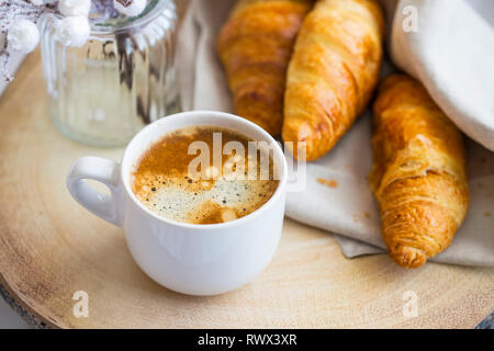 Cup of capuccino coffee with croissants, morning breakfast Stock Photo