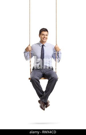 Full length portrait of a young professional man sitting on a swing and smiling at the camera isolated on white background Stock Photo