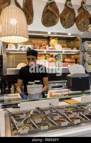 Ferrara, Italy - June 10, 2017: Inside small Italian food and mini market with  staff at work in Ferrara. Italy Stock Photo