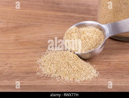 Closeup of celery salt seasoning and a measuring spoon on a wooden table with copy space Stock Photo
