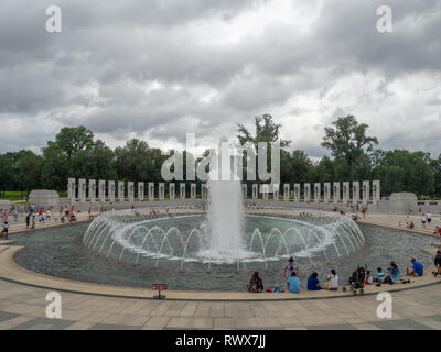 Washington DC, District of Columbia, Summer 2018 [United States US, World War II Memorial, park with Reflecting Pool, falling dusk, dark cloudy sky be Stock Photo