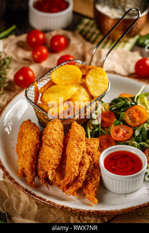 Fried Shrimps tempura with sweet chili sauce, fresh salad and fried potatoes Stock Photo