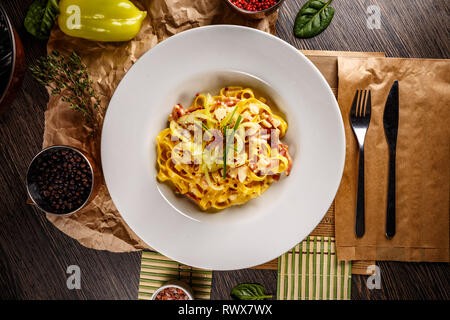 A plate of delicious pasta carbonara with fettuccine, bacon, parsley, parmesan cheese Stock Photo