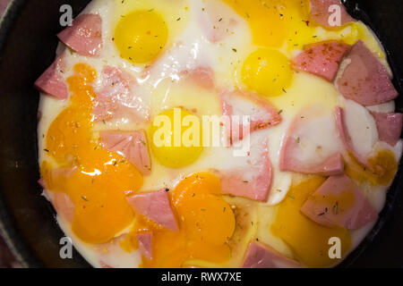fried eggs in a pan with sausage. Cook at home. fried food. unhealthy food. morning breakfast Stock Photo