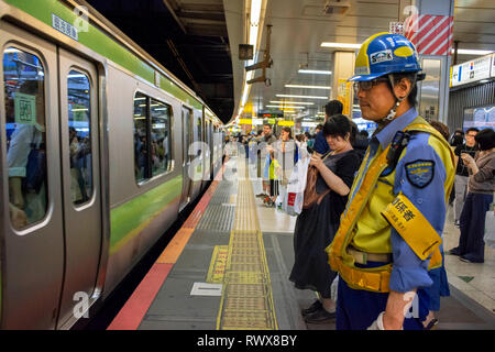 Japanese people in underground station, Asian commuters traveling during rush hour, tourists on subway train. Tokyo, Japan, Asia Stock Photo