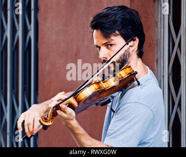 Busking violinist on the streets of Malaga Stock Photo